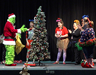  Singing Hills office staff stage a Grinch-themed skit at their holiday assembly.